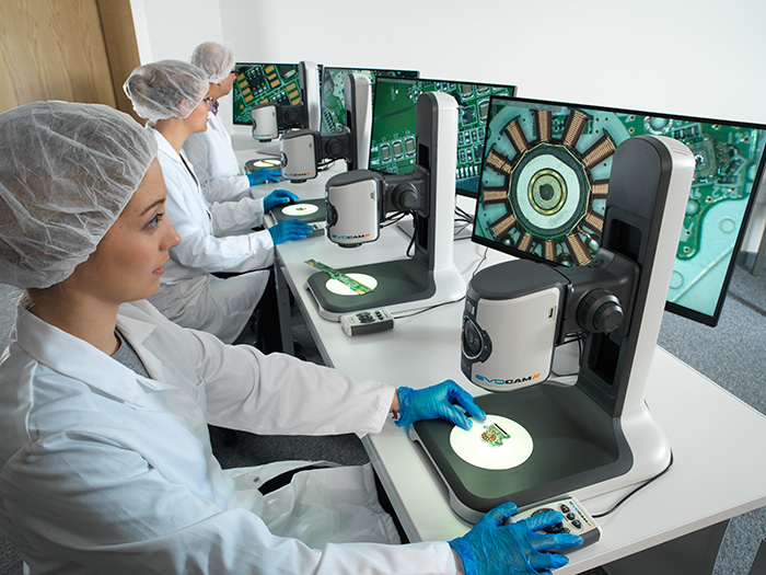 Operators inspecting PCB boards with EVO Cam II